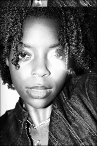 a black and white photo of a woman with curly hair