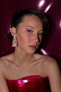 a woman in a pink dress posing for a photo